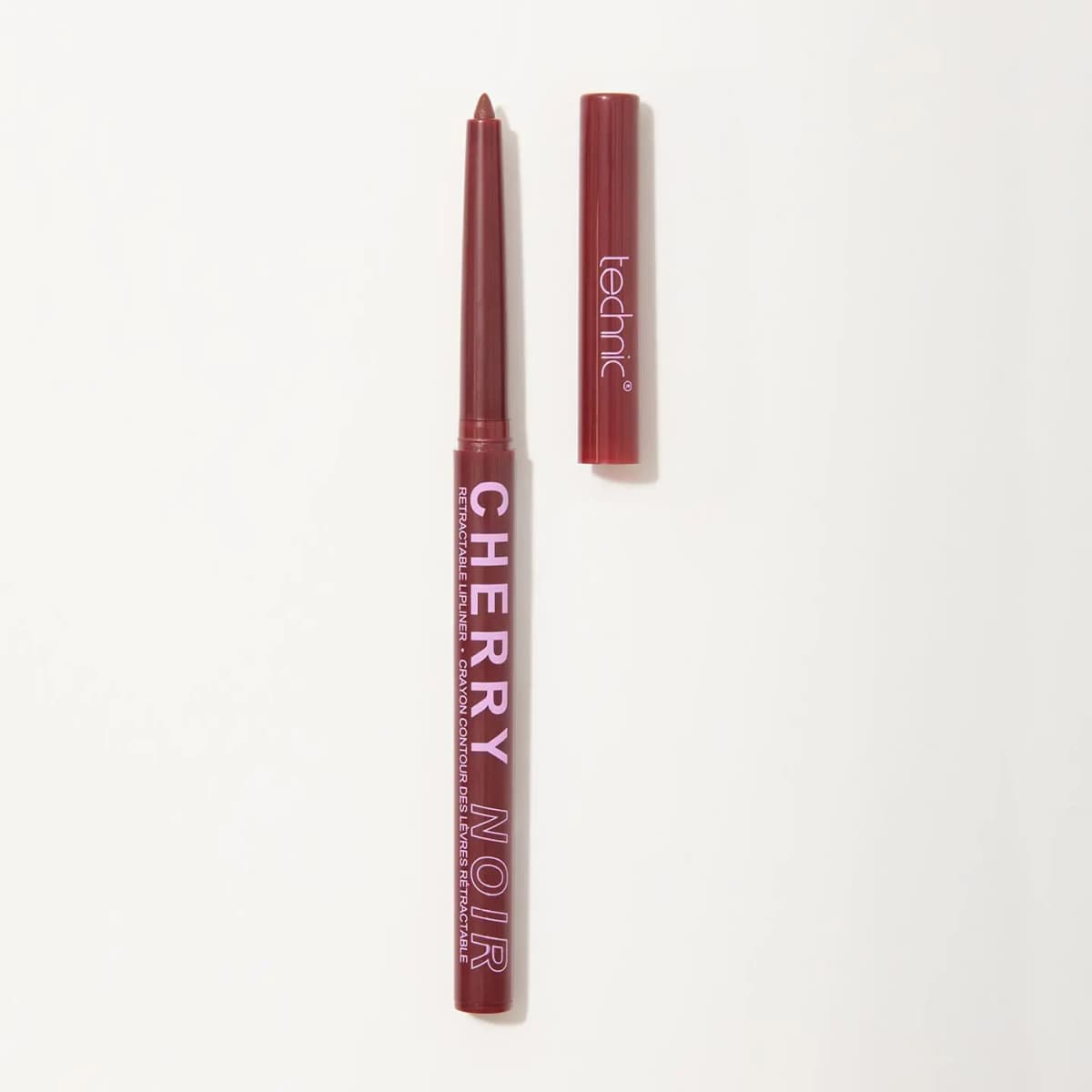Cherry Noir retractable lip liner in burgundy, twisted up beside its Technic-branded cap on white