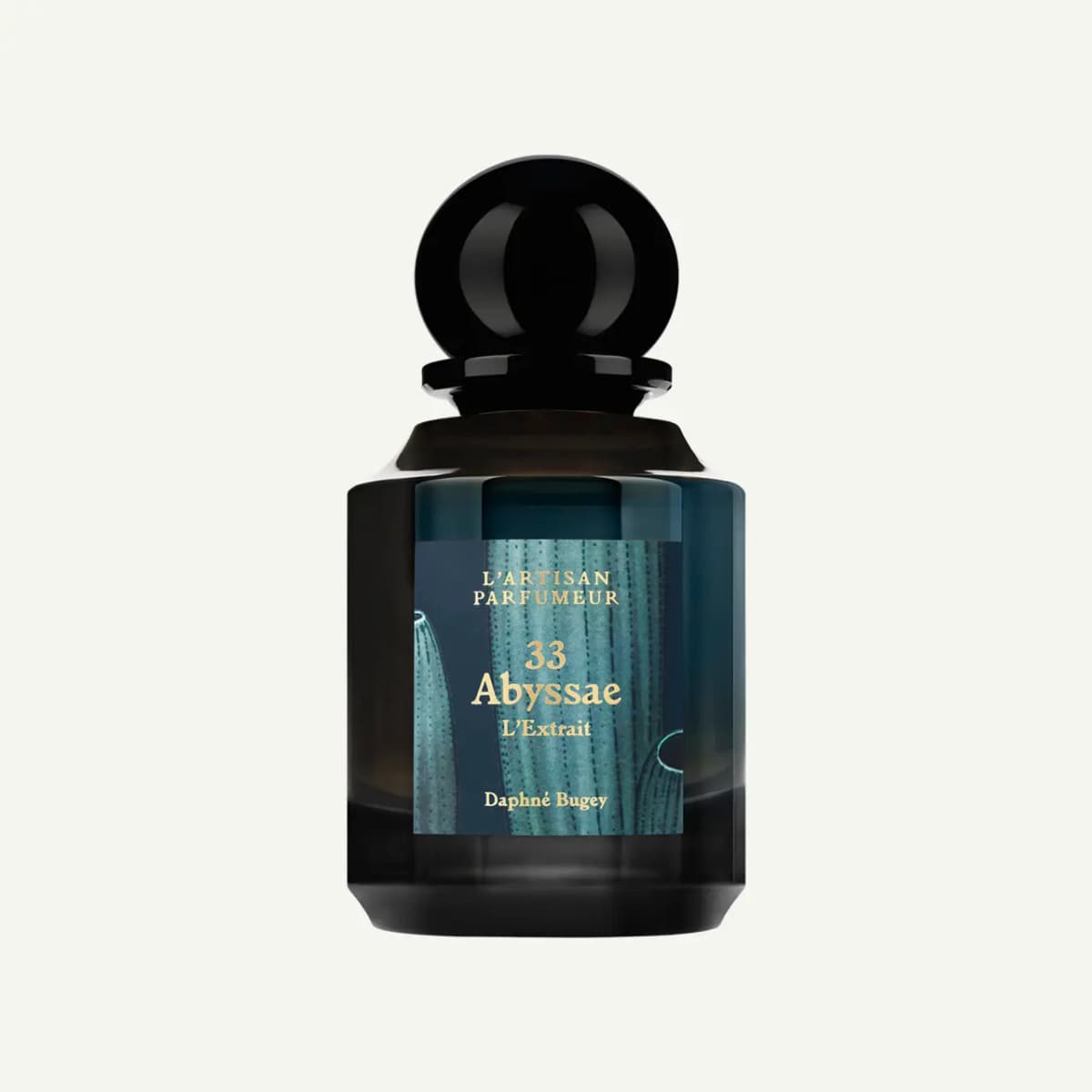 L'Artisan Parfumeur 33 Abyssae L'Extrait bottle with black sphere cap and teal sea-sponge label on an off-white background