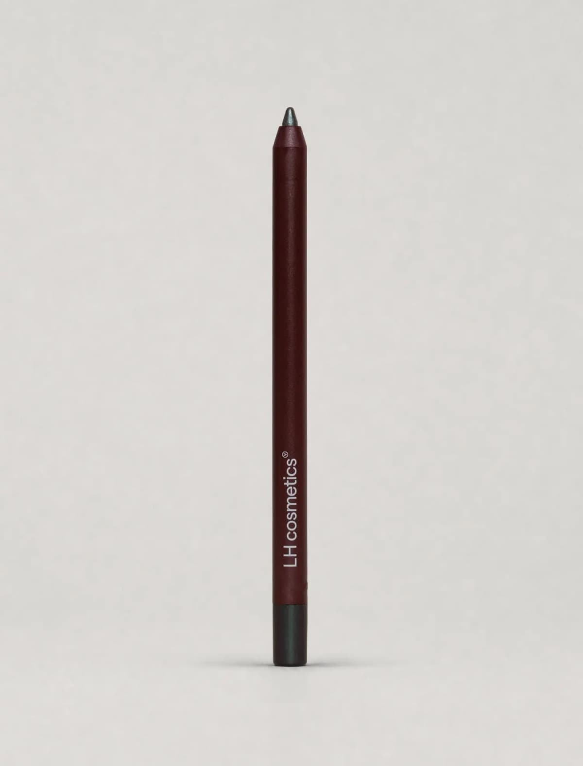 Burgundy pencil with a dark green-grey metallic tip and end cap, standing against a pale grey backdrop
