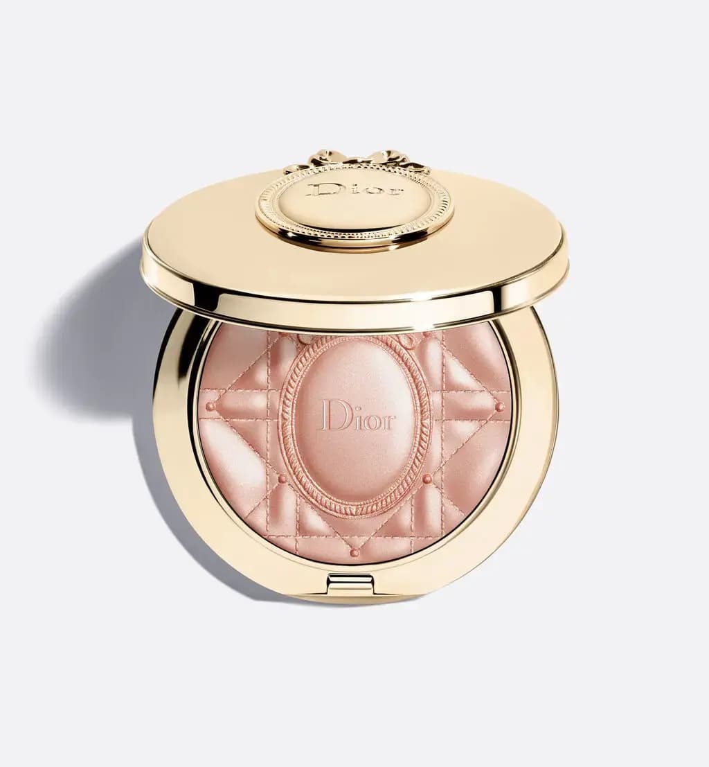 Round gold Dior compact with a bow medallion on the lid, holding rosy highlighter embossed with Cannage and medallion