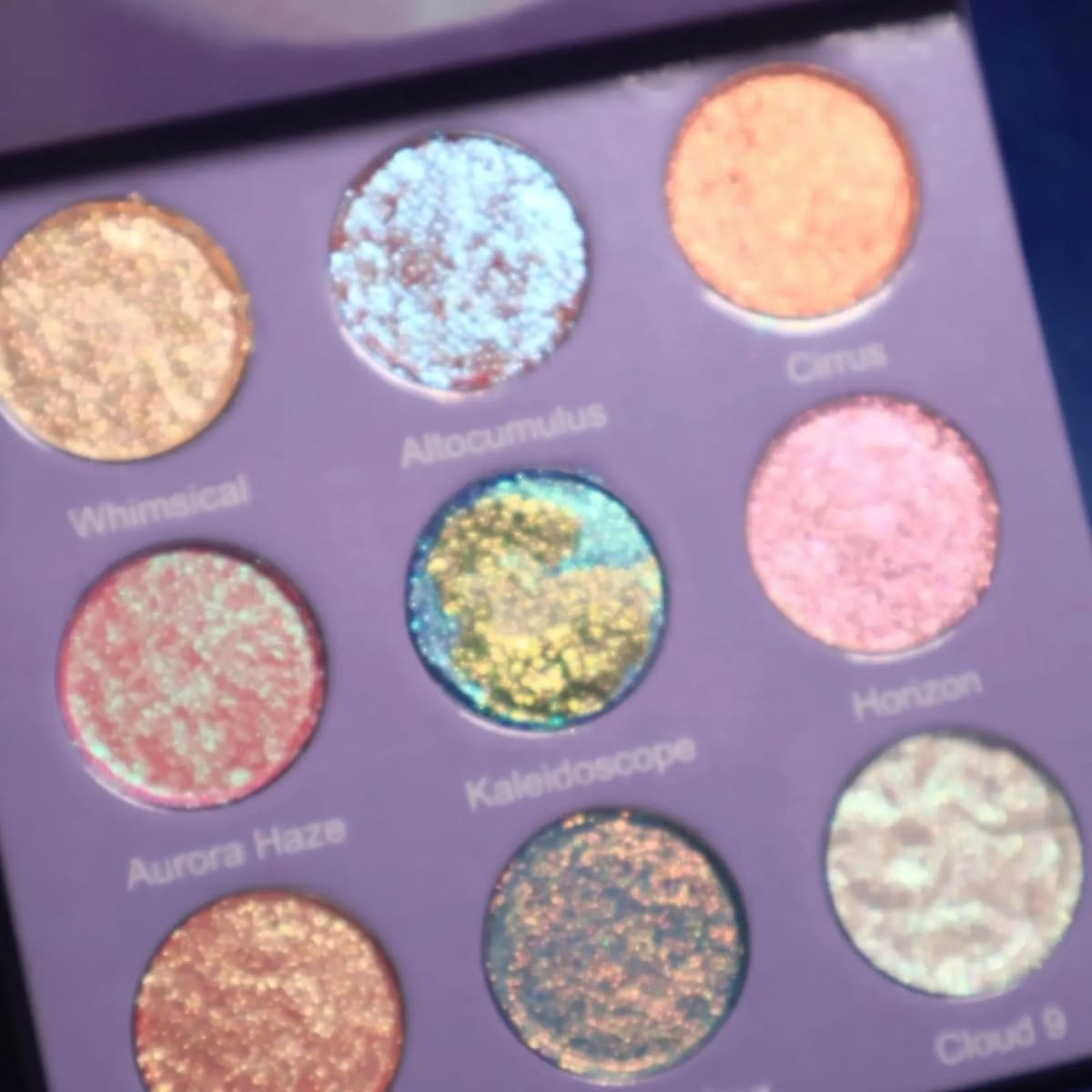 Open palette close-up showing sparkly shades Whimsical, Altocumulus, Cirrus, Aurora Haze, Kaleidoscope, Horizon and Cloud 9