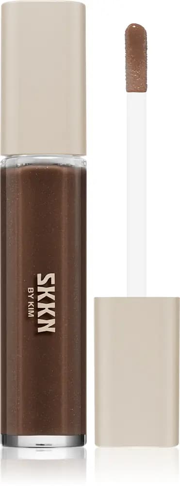SKKN by Kim liquid lip product in a deep brown shade with a beige cap and doe-foot applicator