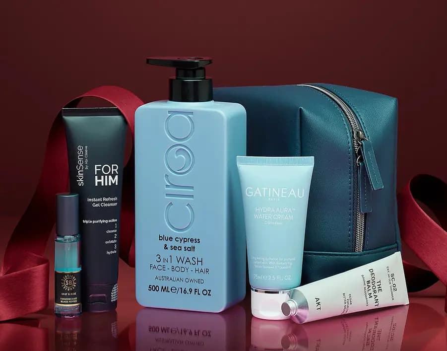 Teal leather wash bag with red ribbon, Ciraa 3-in-1 wash, Gatineau water cream, skinSense For Him cleanser and AKT balm.
