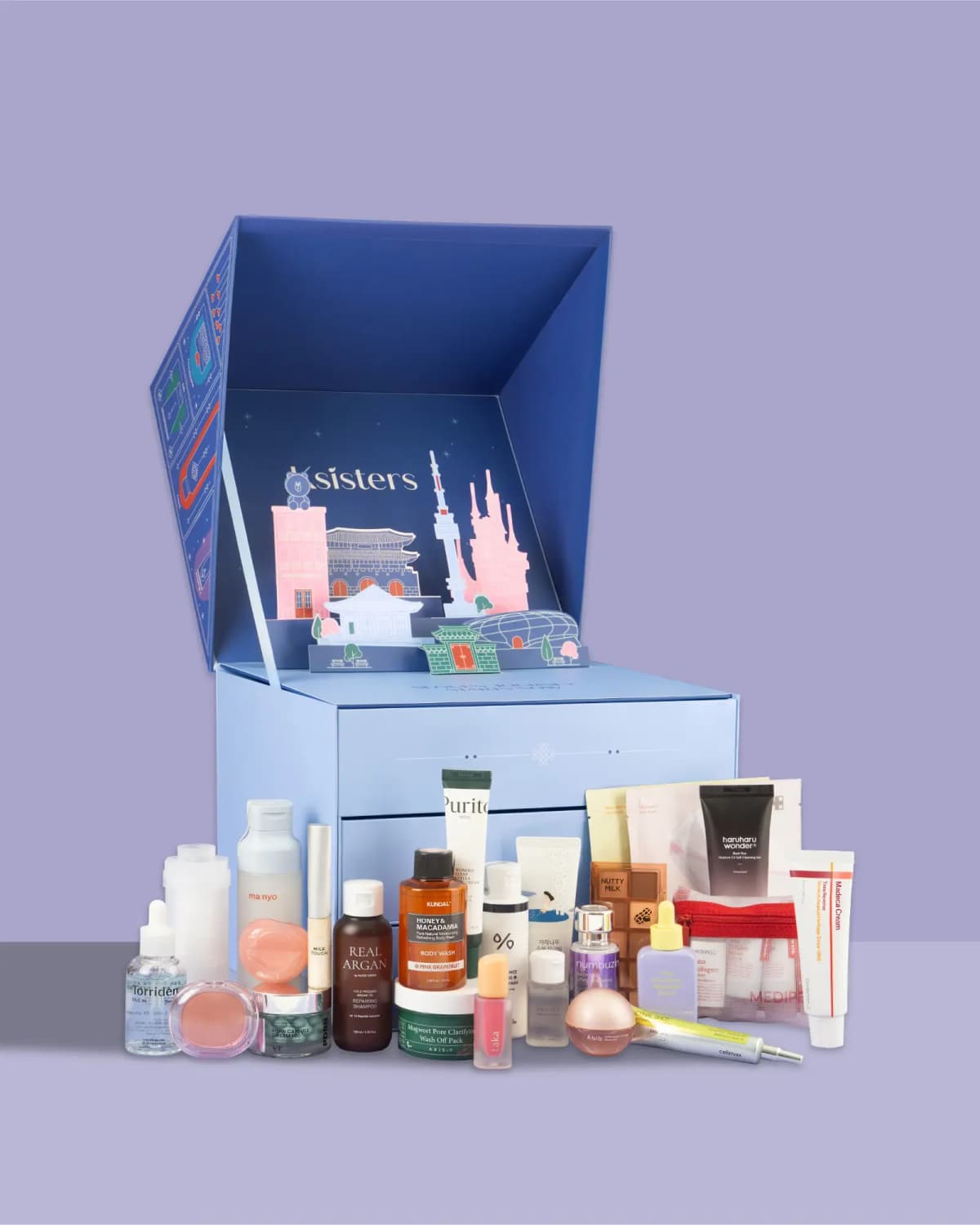 Calendar opened to show a pop-up Seoul skyline, light blue drawers and products including Torriden serum and Laka tint