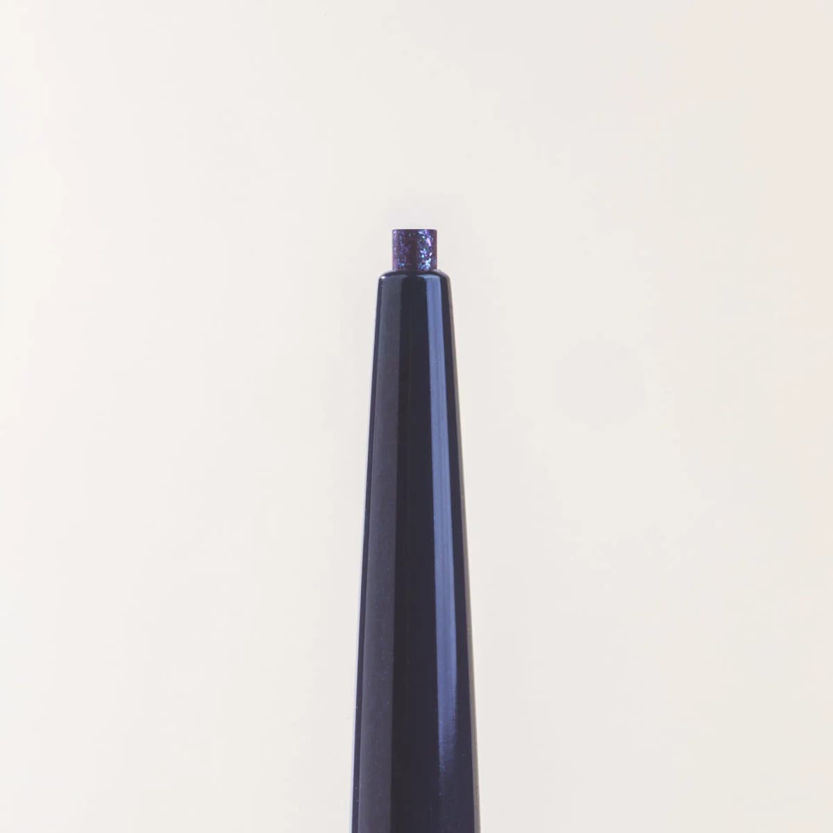 Close-up of the retractable tip showing Blue Amber's dark lead flecked with purple and sky-blue glitter.