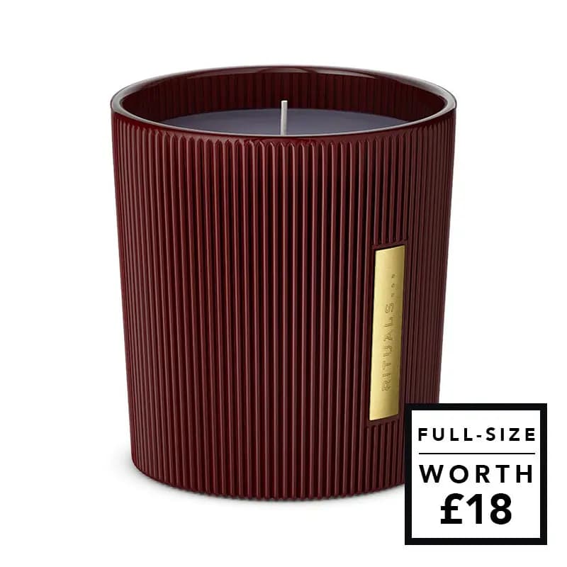 Ribbed burgundy Rituals candle in a glass with a gold label, full-size worth £18
