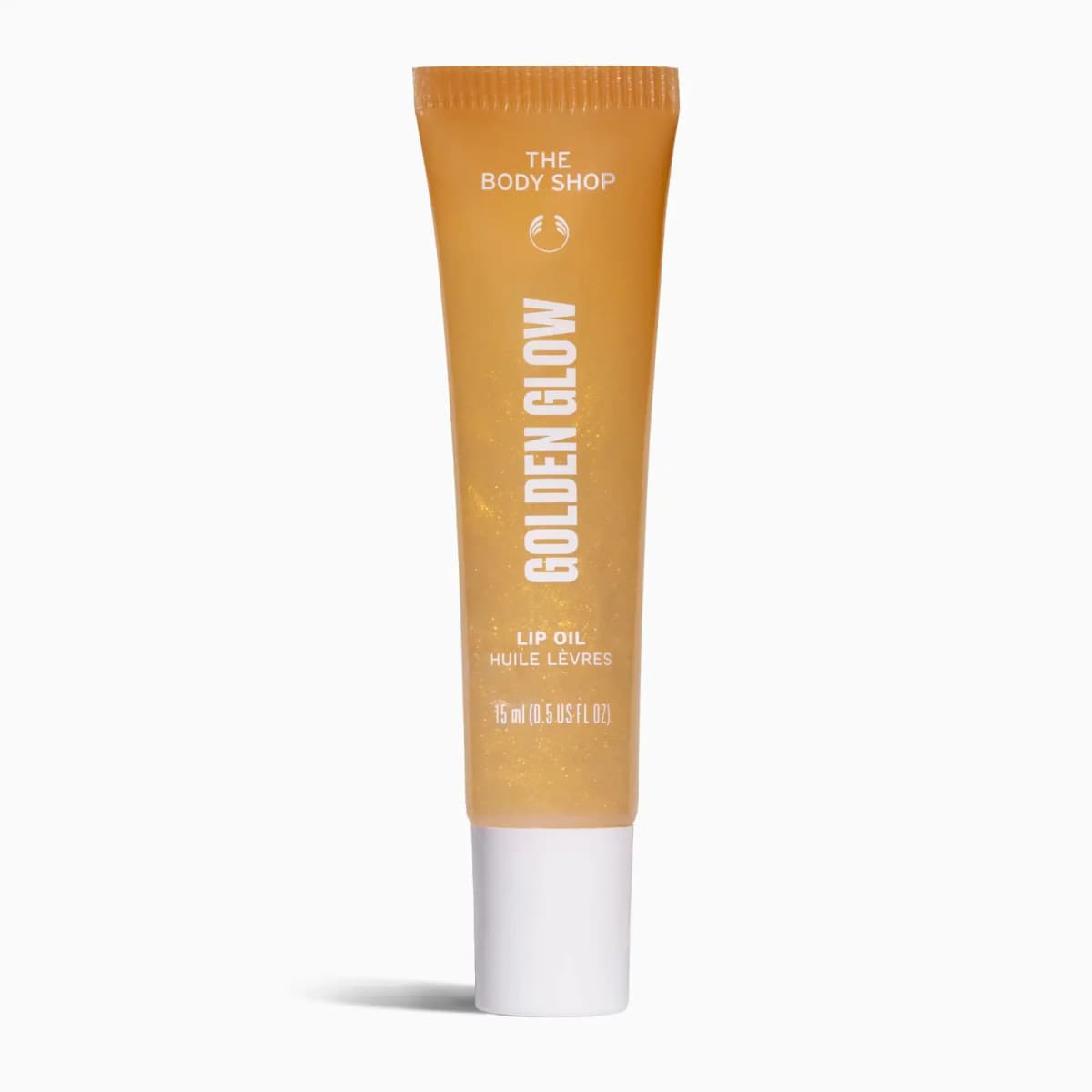 Golden Glow lip oil in a gold-flecked orange tube with white cap