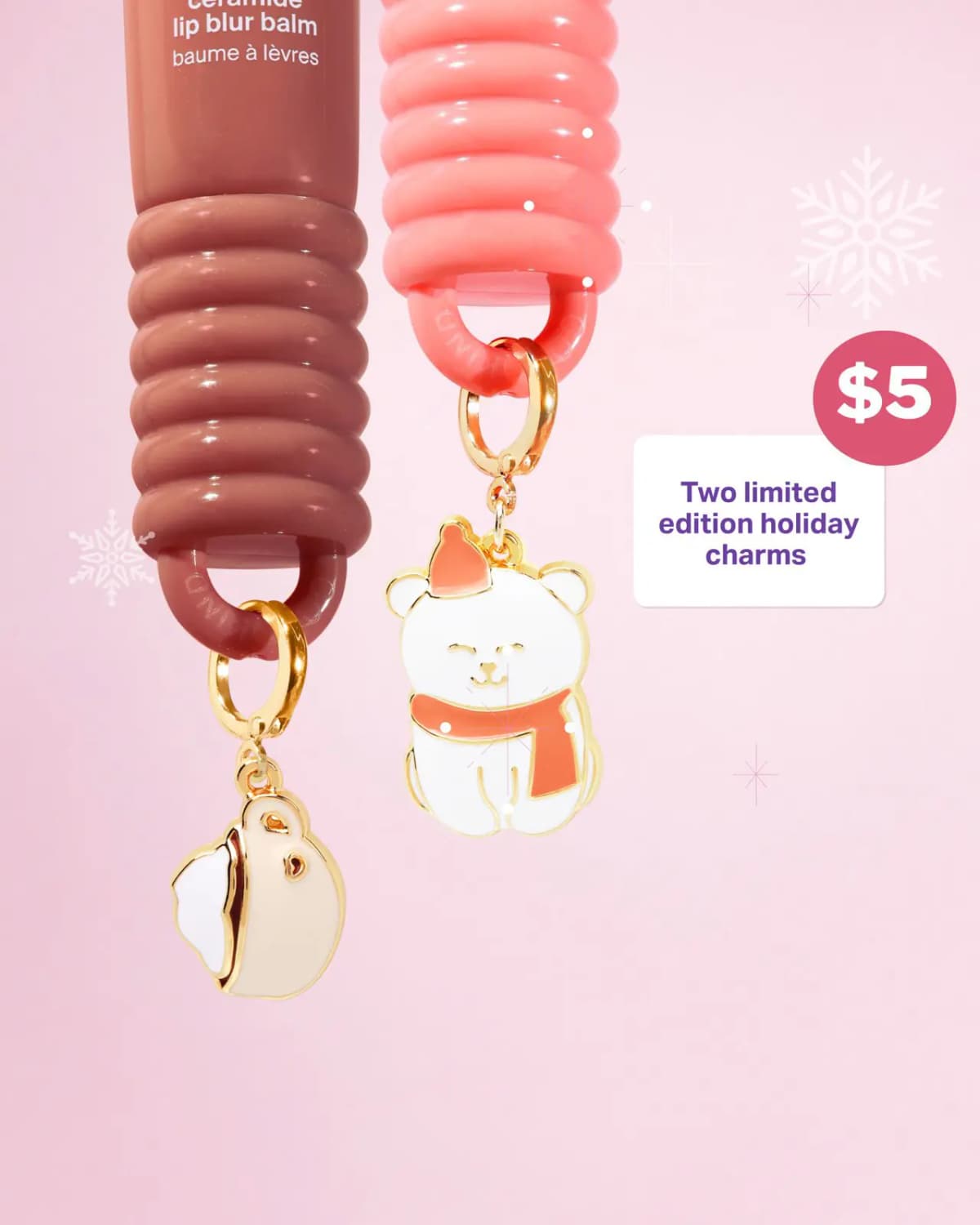Brown and coral balm tubes with gold-trimmed cup and polar bear holiday charms, priced at $5