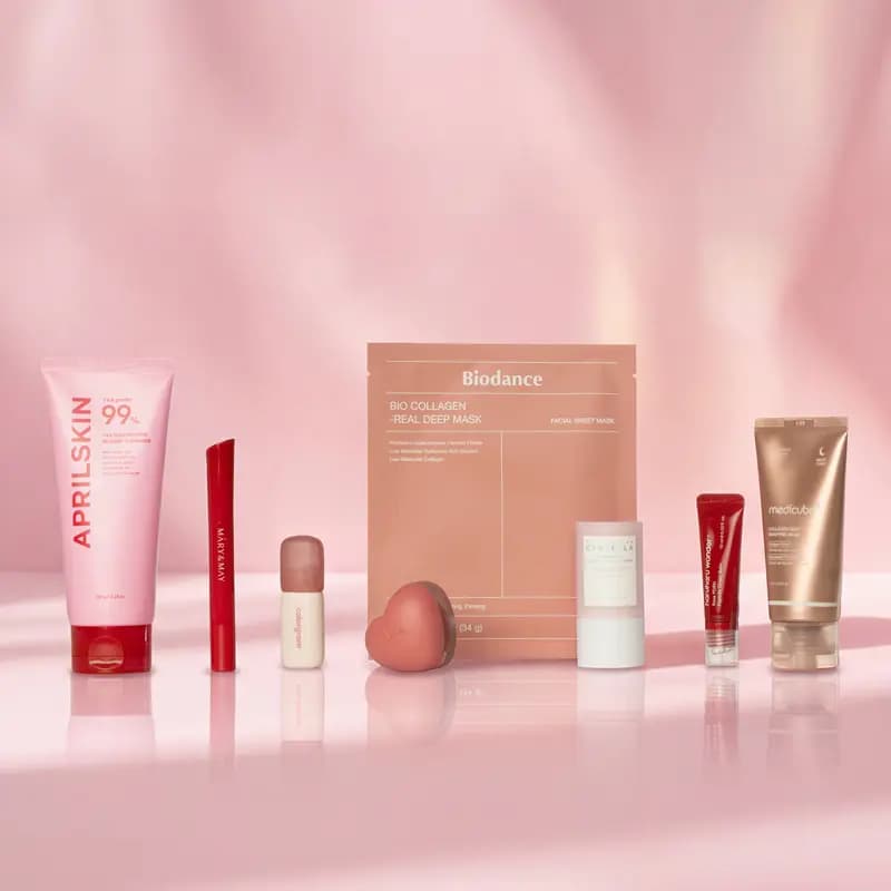 Pink-toned K-beauty products: AprilSkin 99%, Mary & May, colorgram, Biodance collagen mask and medicube tube