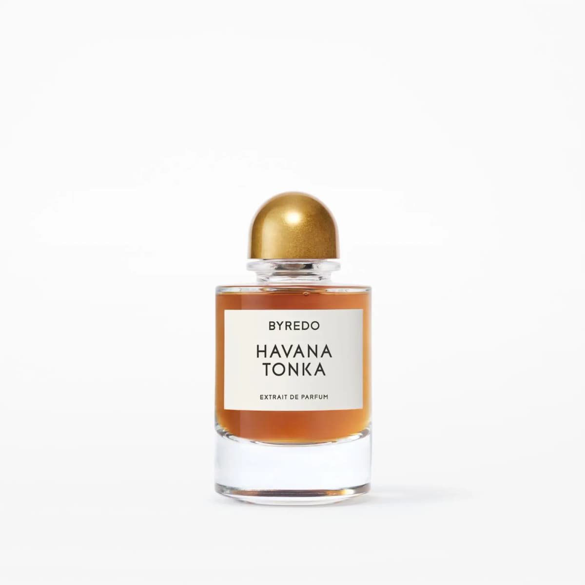 Byredo Havana Tonka Extrait de Parfum bottle with amber liquid, white label and domed gold cap on a white background