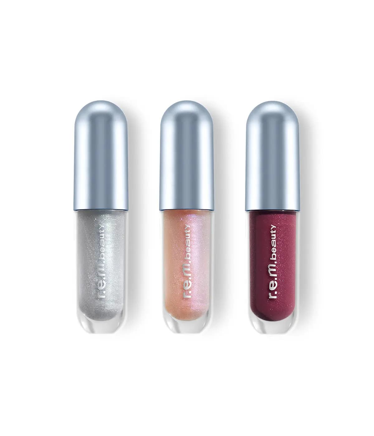 Three mini glosses from The Gloss Barre in sparkling silver, iridescent peach and shimmering berry