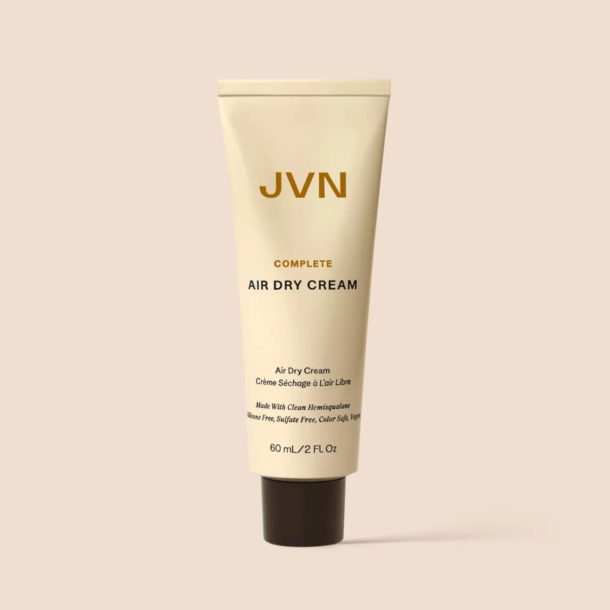 JVN Complete Air Dry Cream in a cream-coloured 60 mL tube with a dark brown cap on a beige background