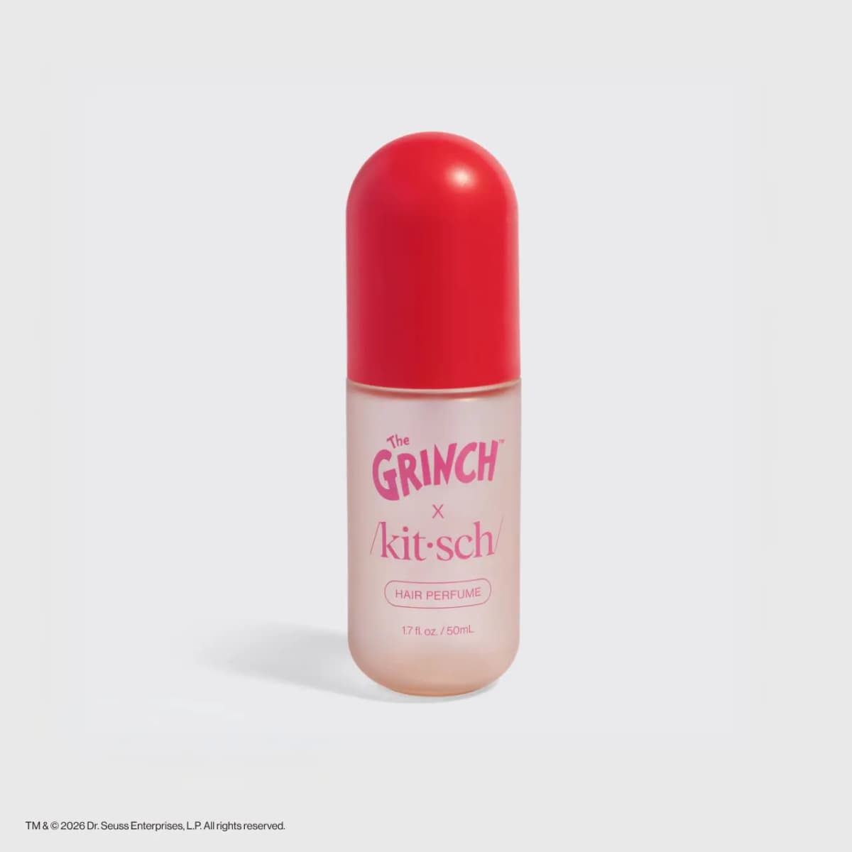 Kitsch x The Grinch Cherry Cheer Hair & Body Perfume Mist in a frosted pink 50mL bottle with a red capsule cap