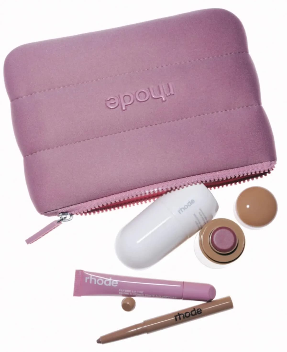 Pink puffy quilted Rhode zip pouch with embossed logo, shown with white lip tube, mauve pot, pink squeeze tube and pencil