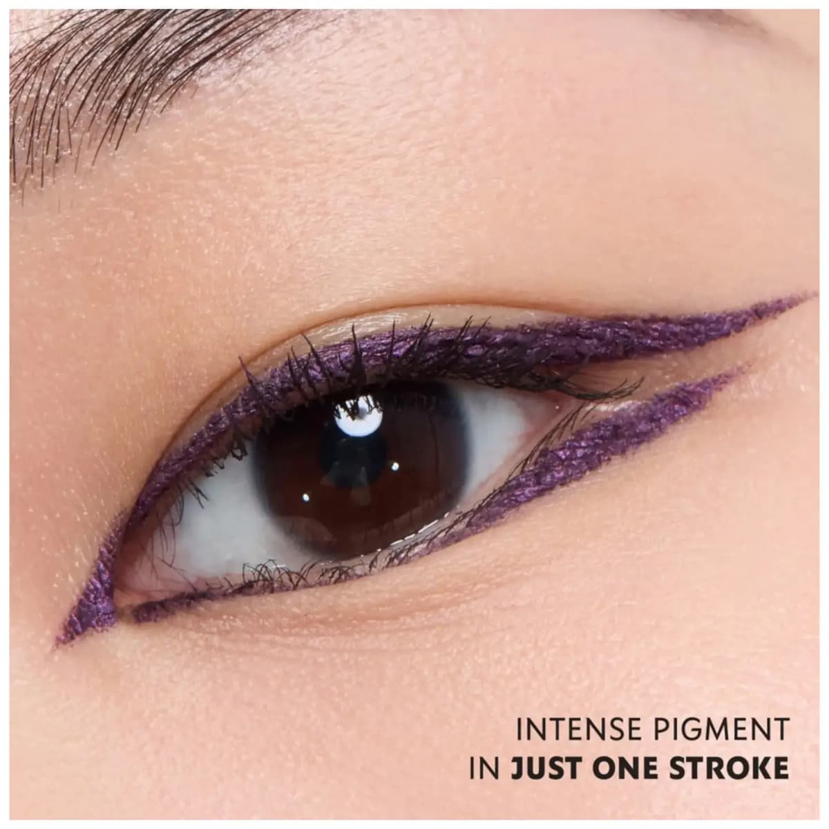 Brown eye with metallic purple double-winged liner on upper and lower lids, captioned "Intense pigment in just one stroke.