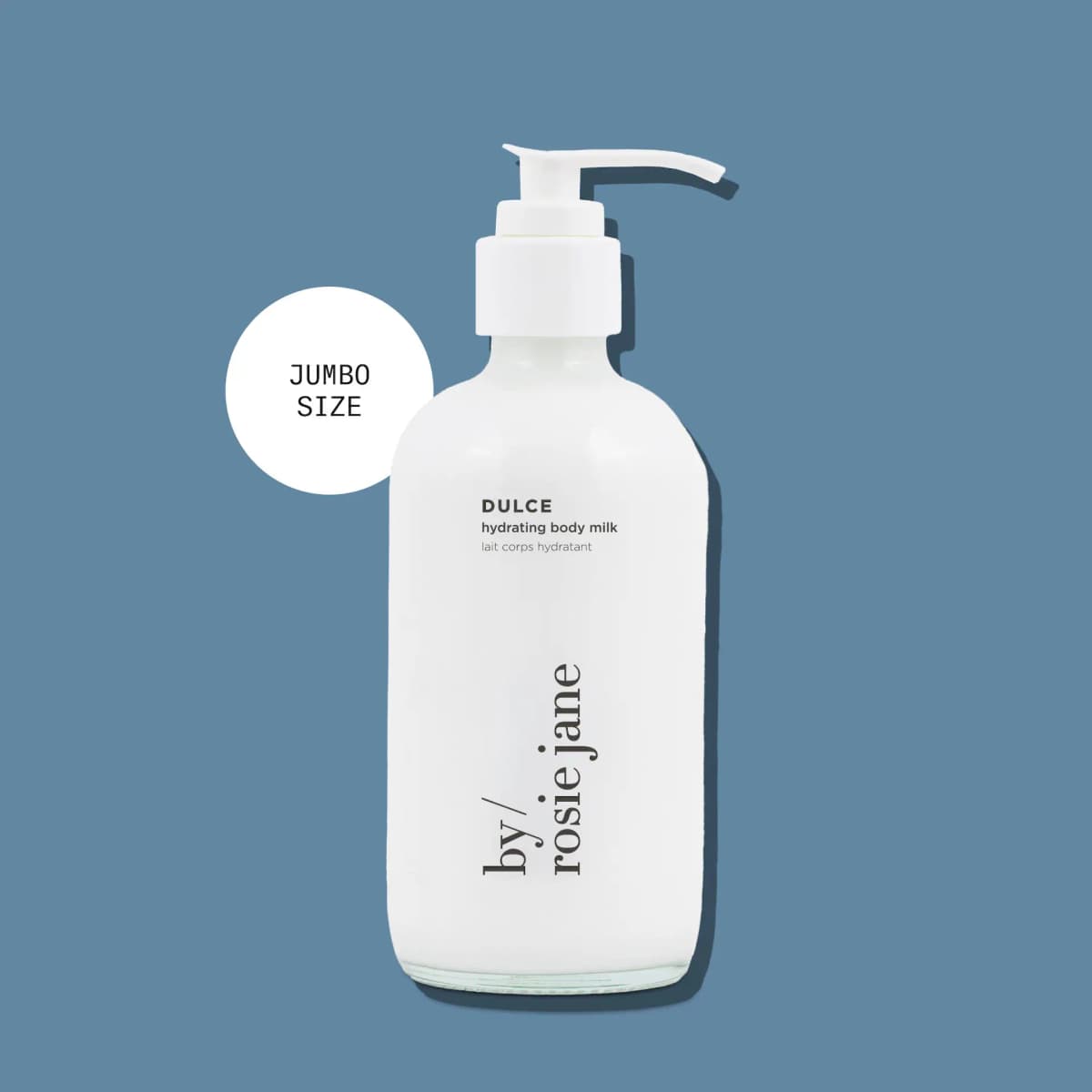 Jumbo size Dulce hydrating body milk in a white pump bottle on a blue background
