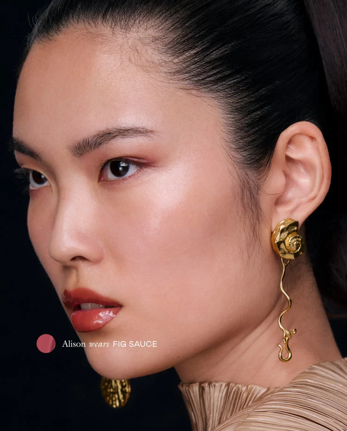 Alison in profile with a gold shell earring wears glossy cool mauve Fig Sauce