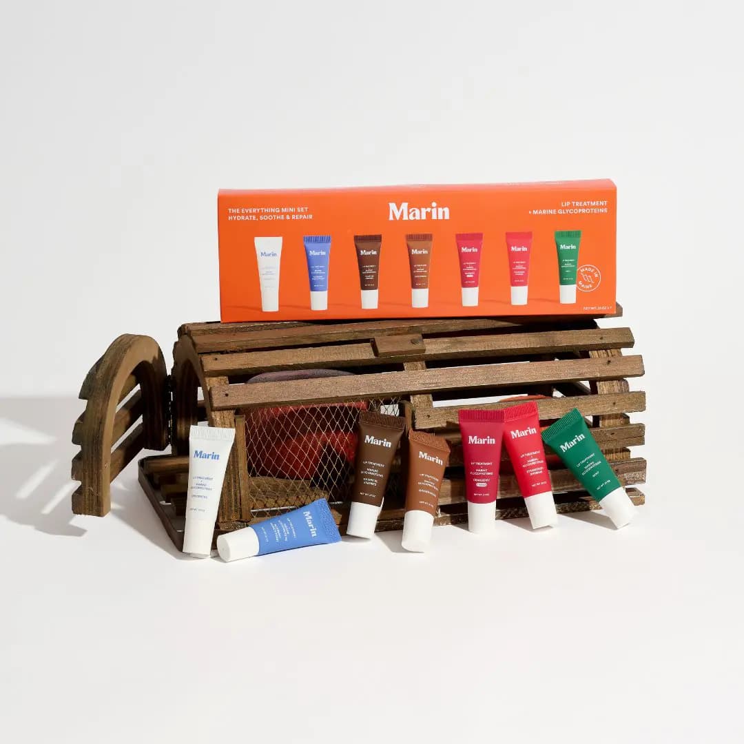 Orange Everything set box resting on a wooden lobster trap with the seven minis leaning against it