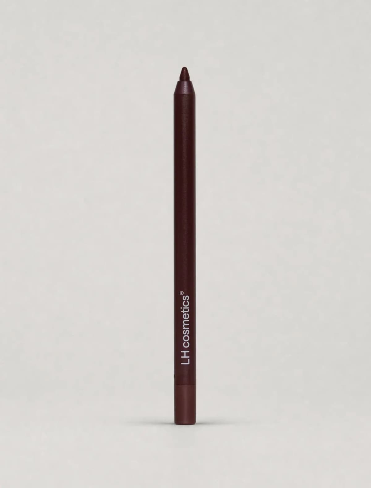 Dark burgundy LH cosmetics pencil with a deep red-brown tip standing upright on a pale grey backdrop