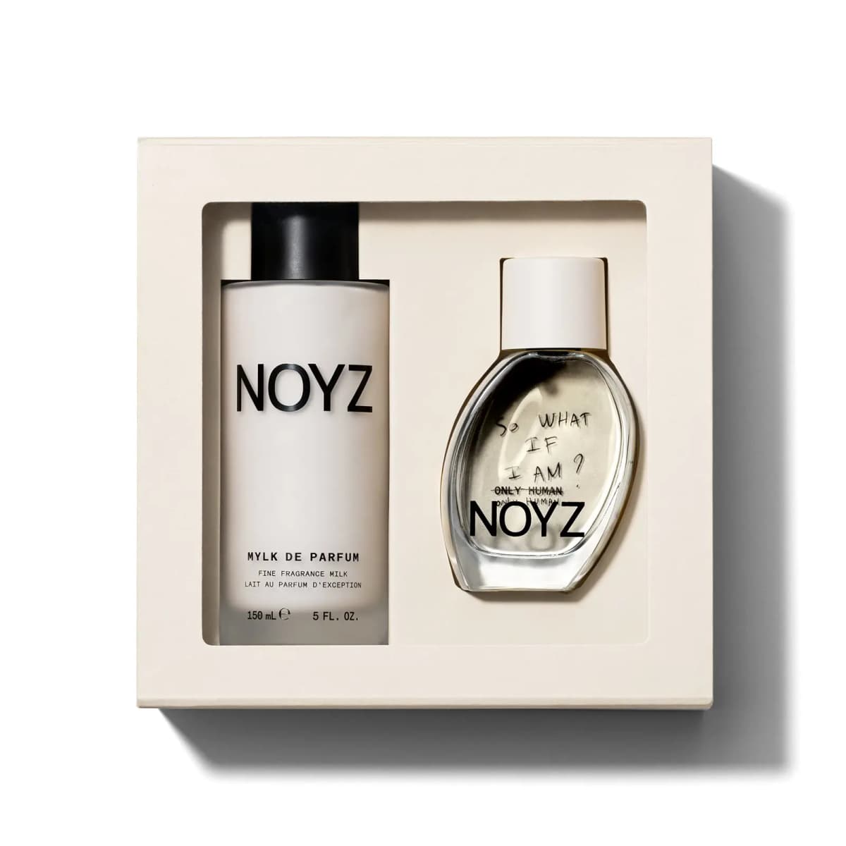 Cream gift box with 150 mL Mylk de Parfum and a scribbled 'So what if I am?' Only Human perfume bottle