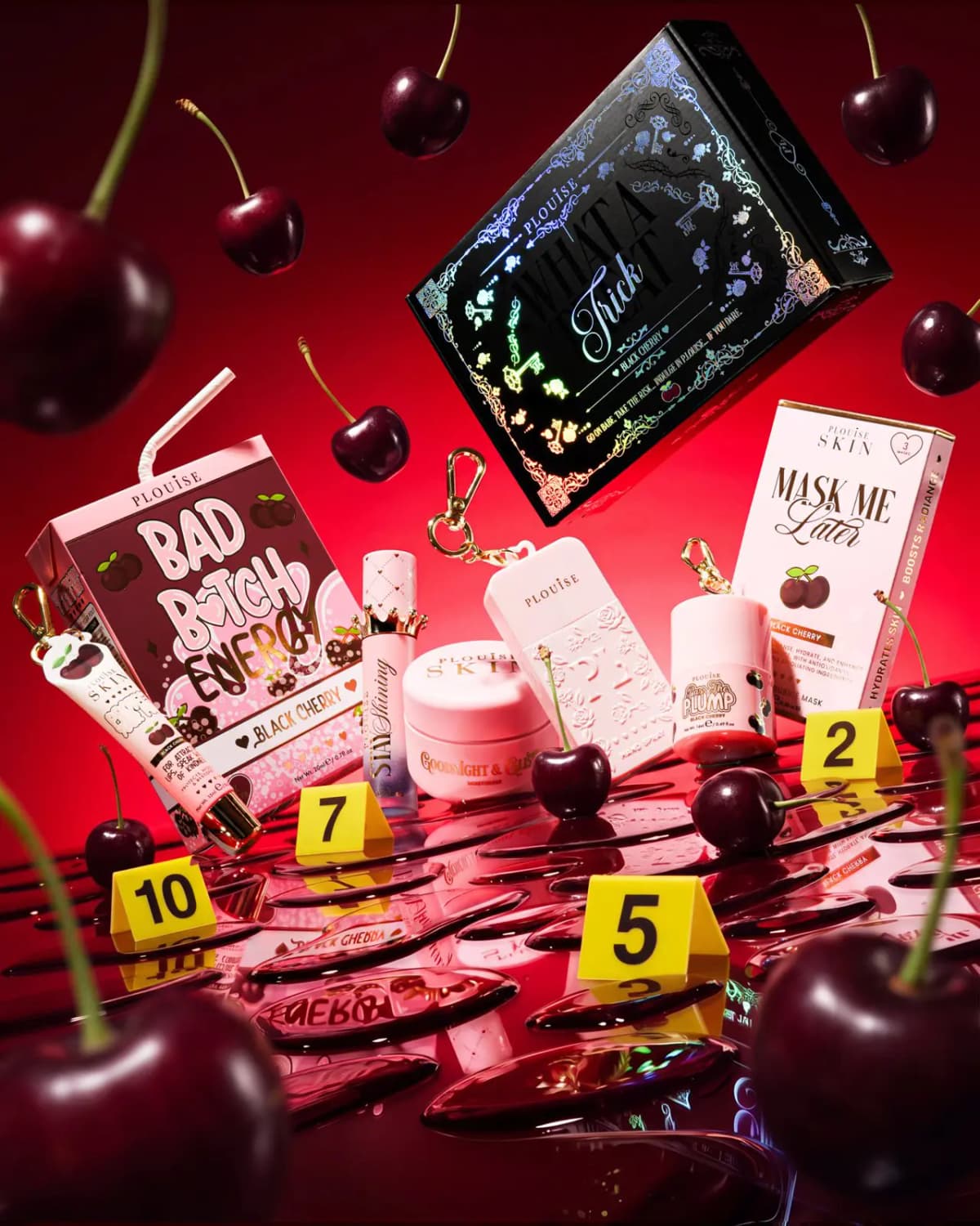Black Cherry set with pink skincare, juice-box lip duo and floating What A Trick box among cherries and evidence markers