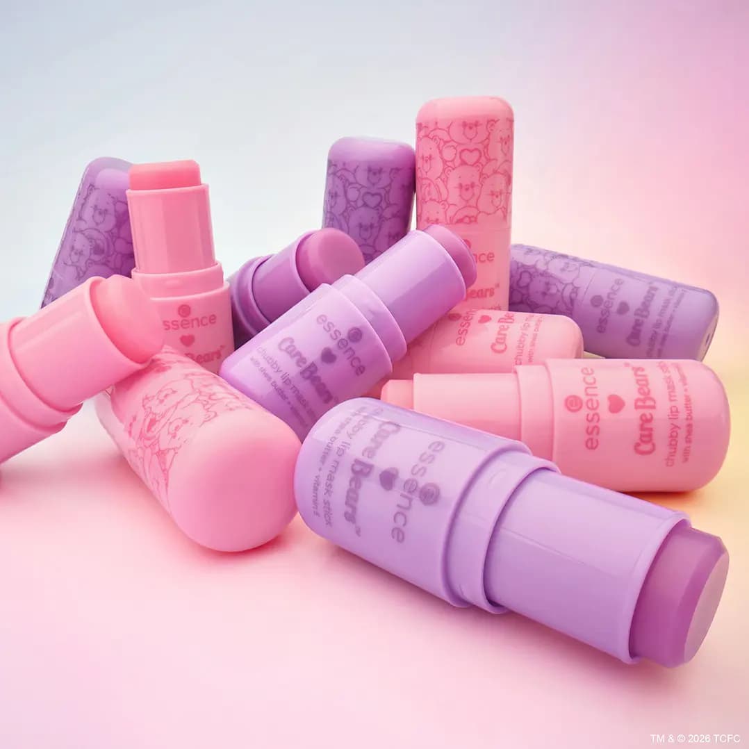 Pile of chubby lip mask sticks in pastel pink and lilac Care Bears printed packaging.
