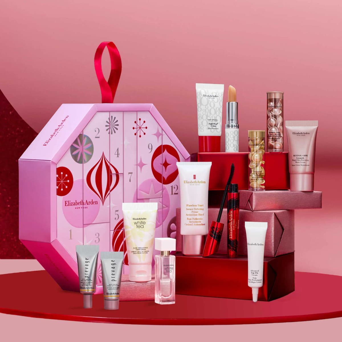 Elizabeth Arden calendar with PREVAGE serums, White Tea hand cream and perfume, and mascara on red and pink gift boxes.