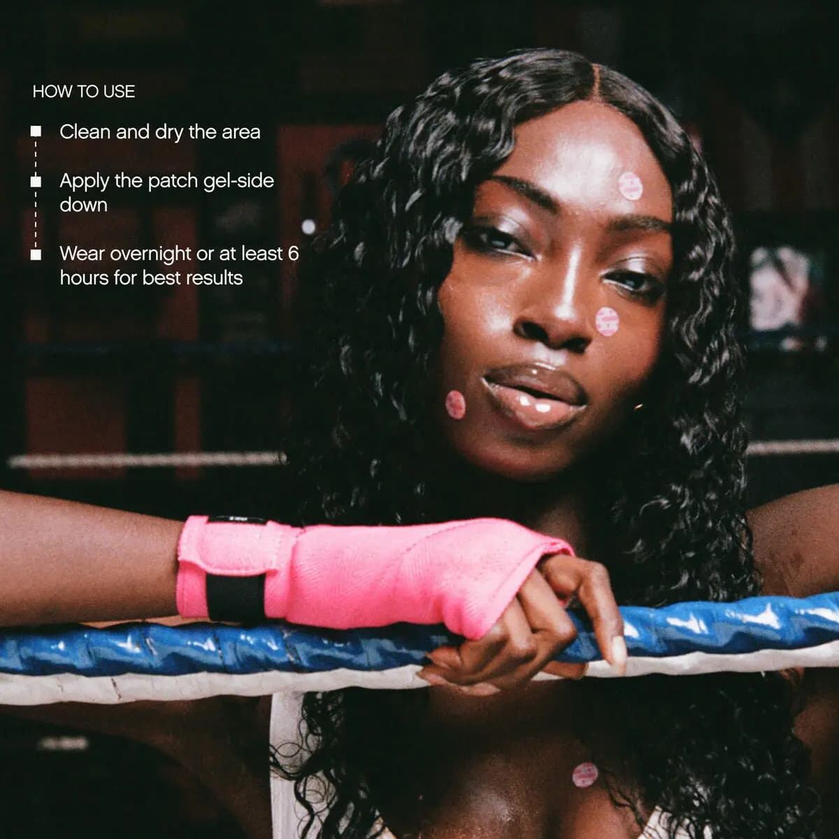 Model in pink hand wraps leaning on a boxing ring rope with pink patches on the face, beside patch how-to-use steps