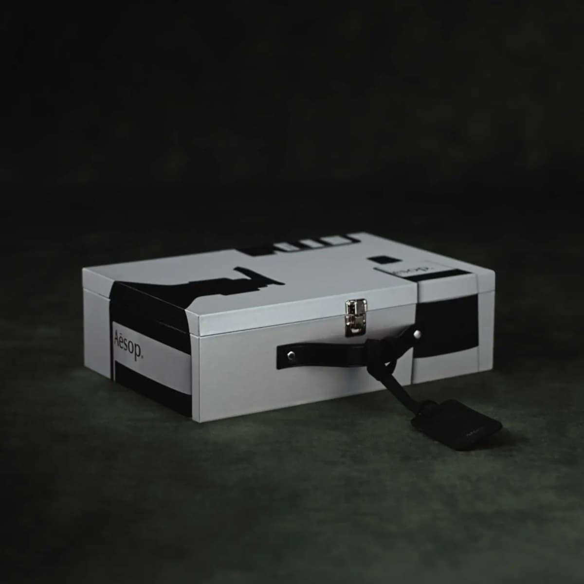 Closed Aesop Valise suitcase calendar in white with bold black bottle graphics