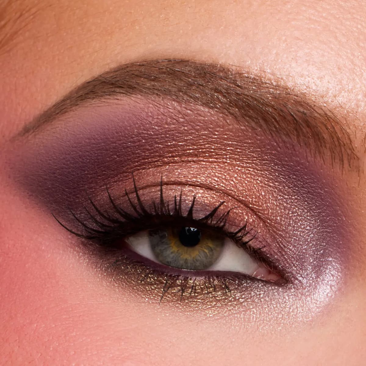 Hazel eye with copper metallic lid, plum matte wing, gold lower lash line and icy pink inner corner