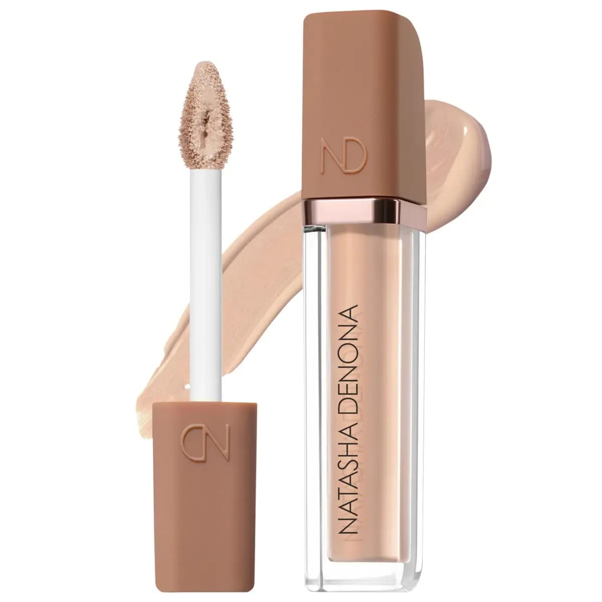 Open concealer tube with tan cap and white applicator wand beside a light beige swatch smear