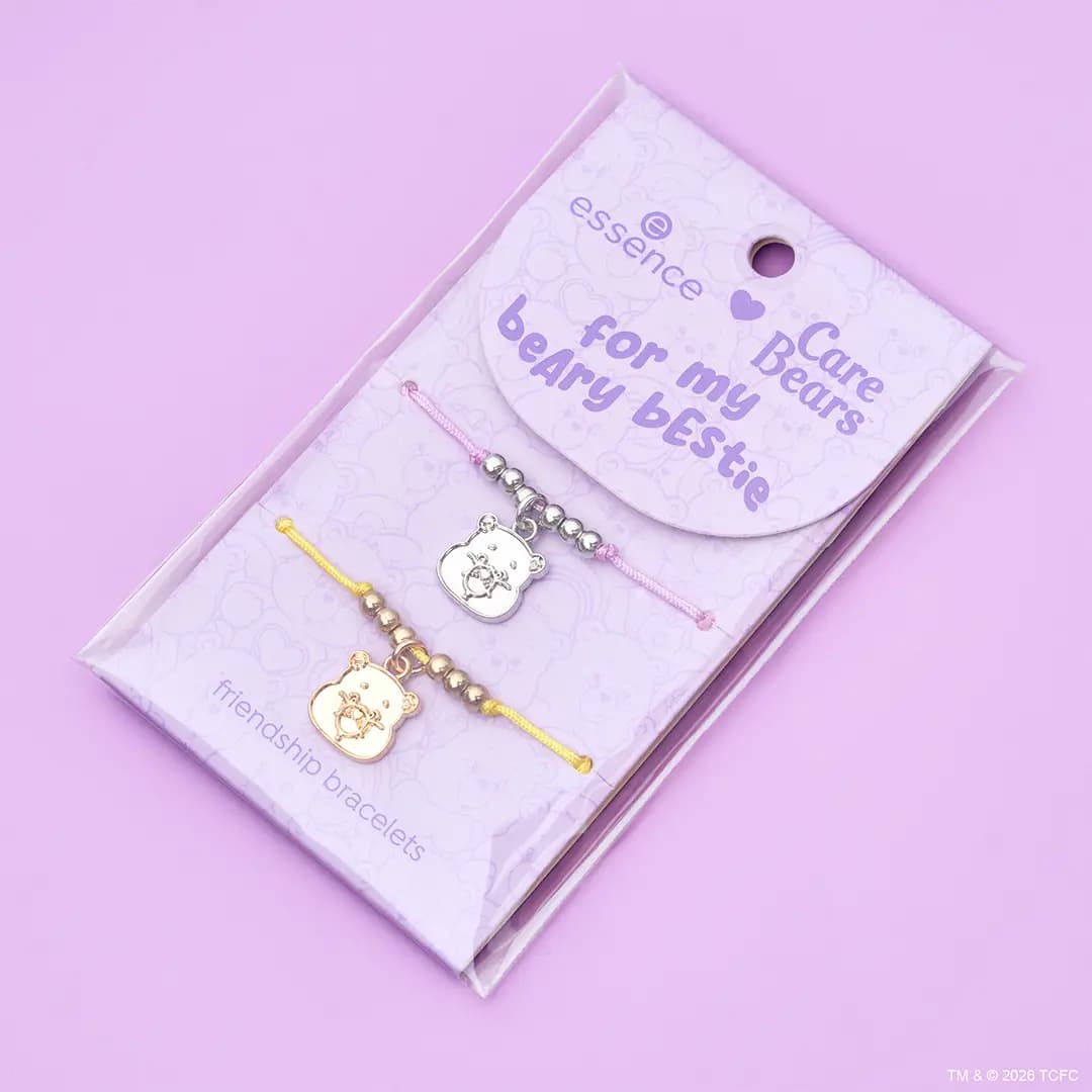 Essence x Care Bears friendship bracelets with silver and gold bear charms on pink and yellow cords in packaging.