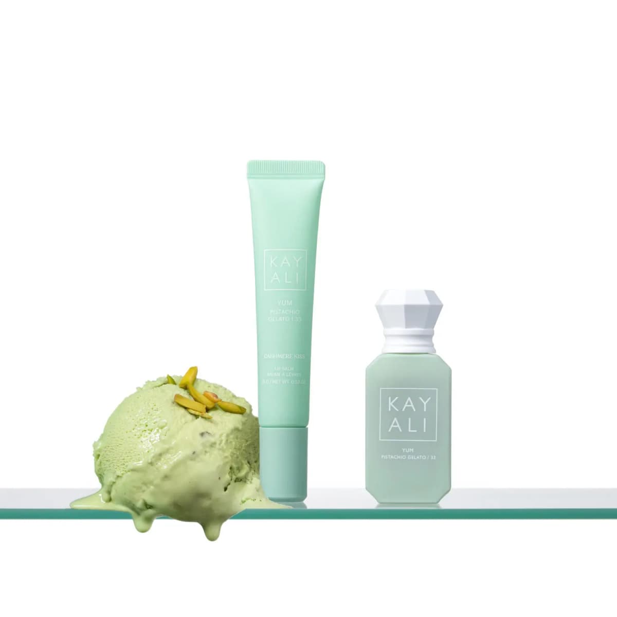 Mint Cashmere Kiss lip balm and Pistachio Gelato perfume beside a melting scoop of pistachio ice cream