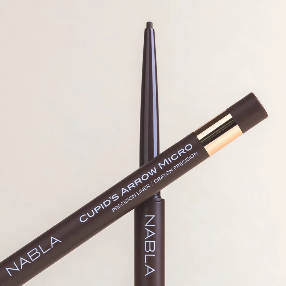 Two Truffle pencils crossed on cream, brown barrels reading Cupid's Arrow Micro Precision Liner.