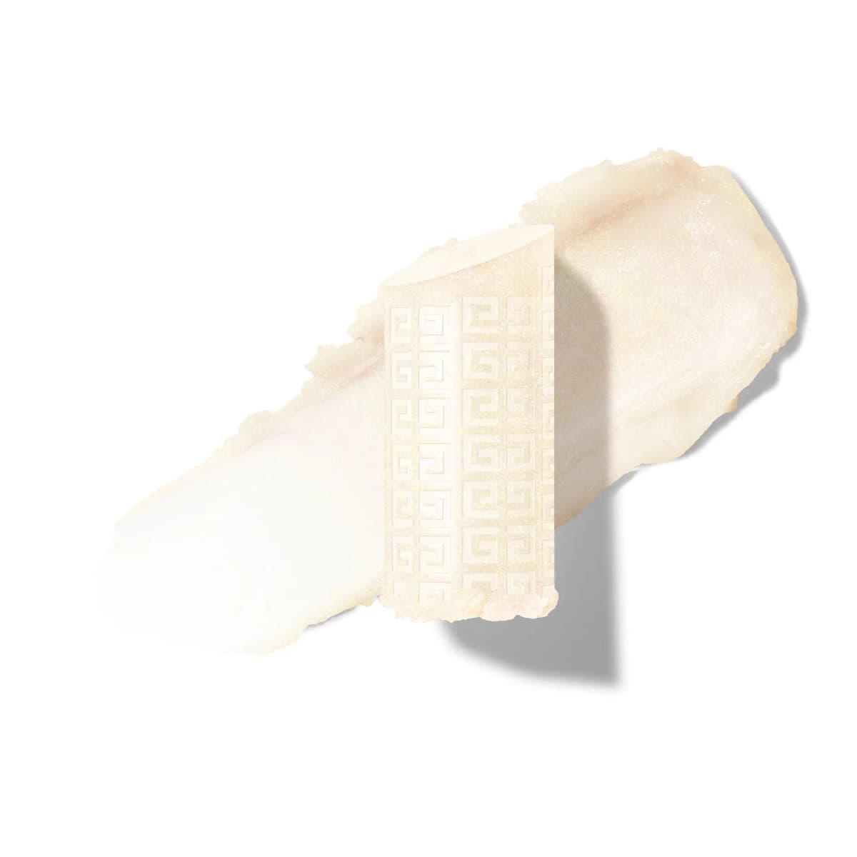 Shimmery ivory balm bullet embossed with an allover 4G pattern resting on a creamy swatch