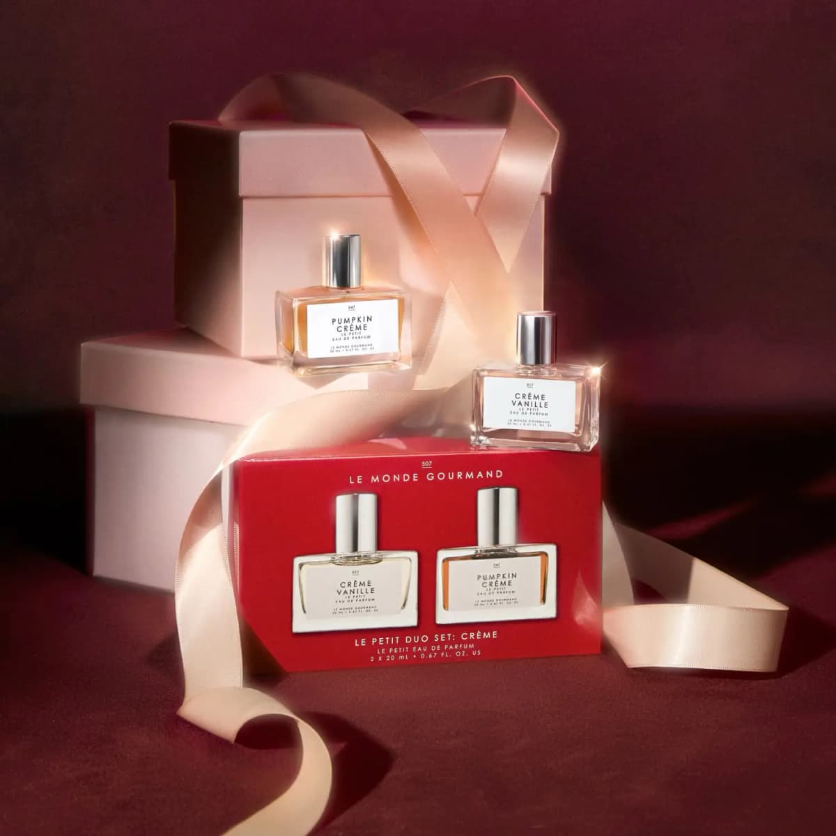 Red Le Petit Duo Set box with Pumpkin Crème and Crème Vanille minis on pink gift boxes tied with satin ribbon