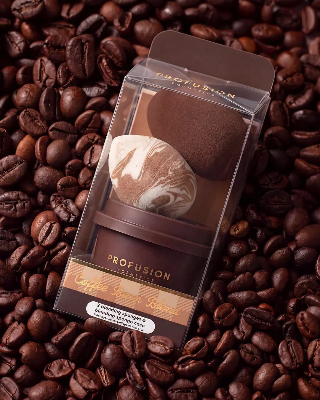 Boxed Coffee Bean Blend blending sponges and cup case set lying on a bed of roasted coffee beans.