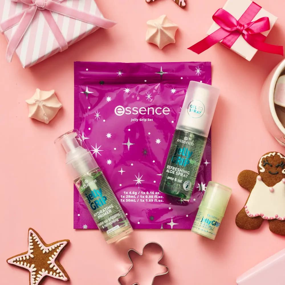Jelly Grip primer, aloe spray and stick on a purple pouch with gifts, meringues and gingerbread on pink