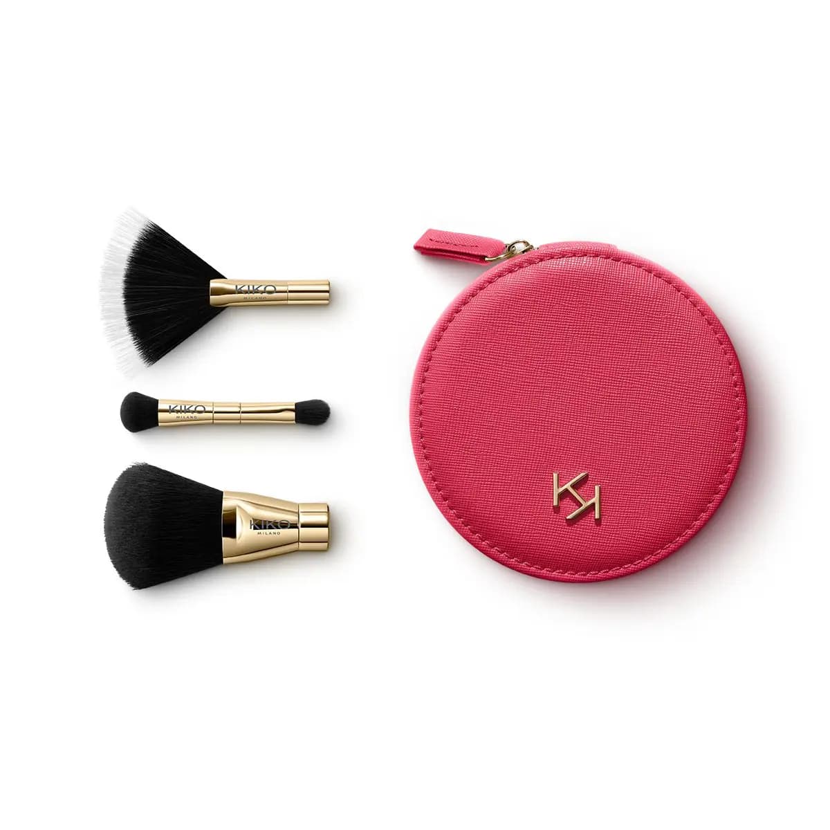Three gold-handled brushes, fan, double-ended and powder, beside a round pink zip pouch with KIKO monogram