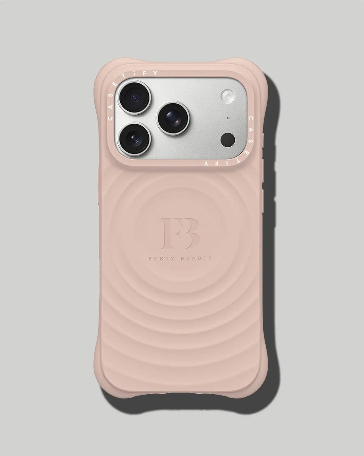 Blush pink bubbly-edged iPhone case with concentric ripple texture and an embossed FB logo