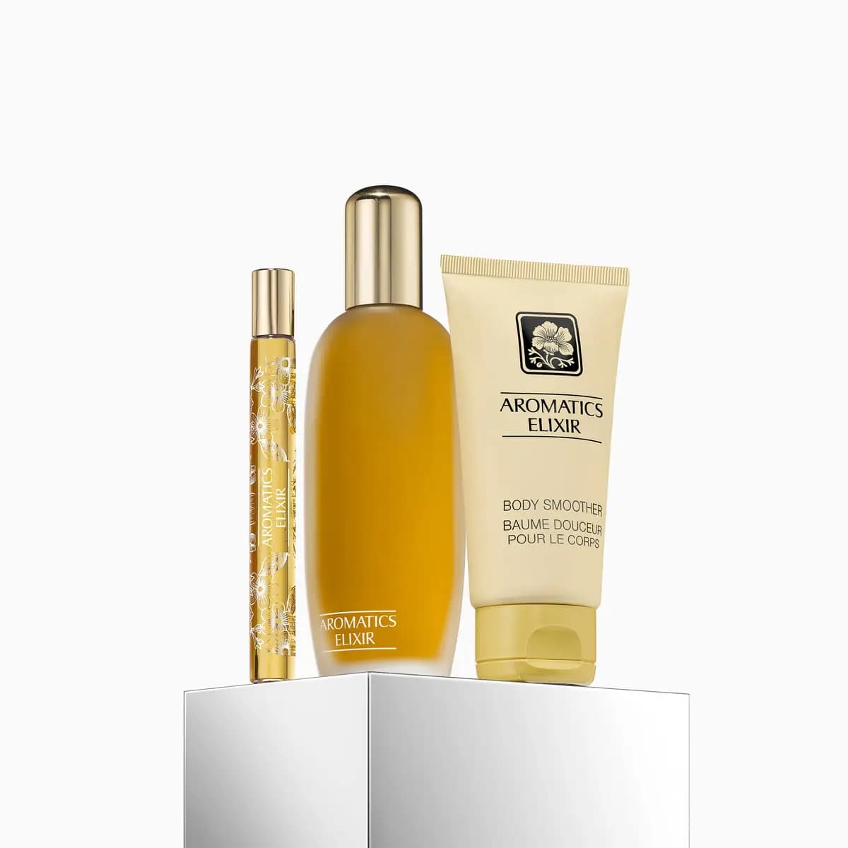 Aromatics Elixir perfume bottle, gold patterned travel spray and Body Smoother tube
