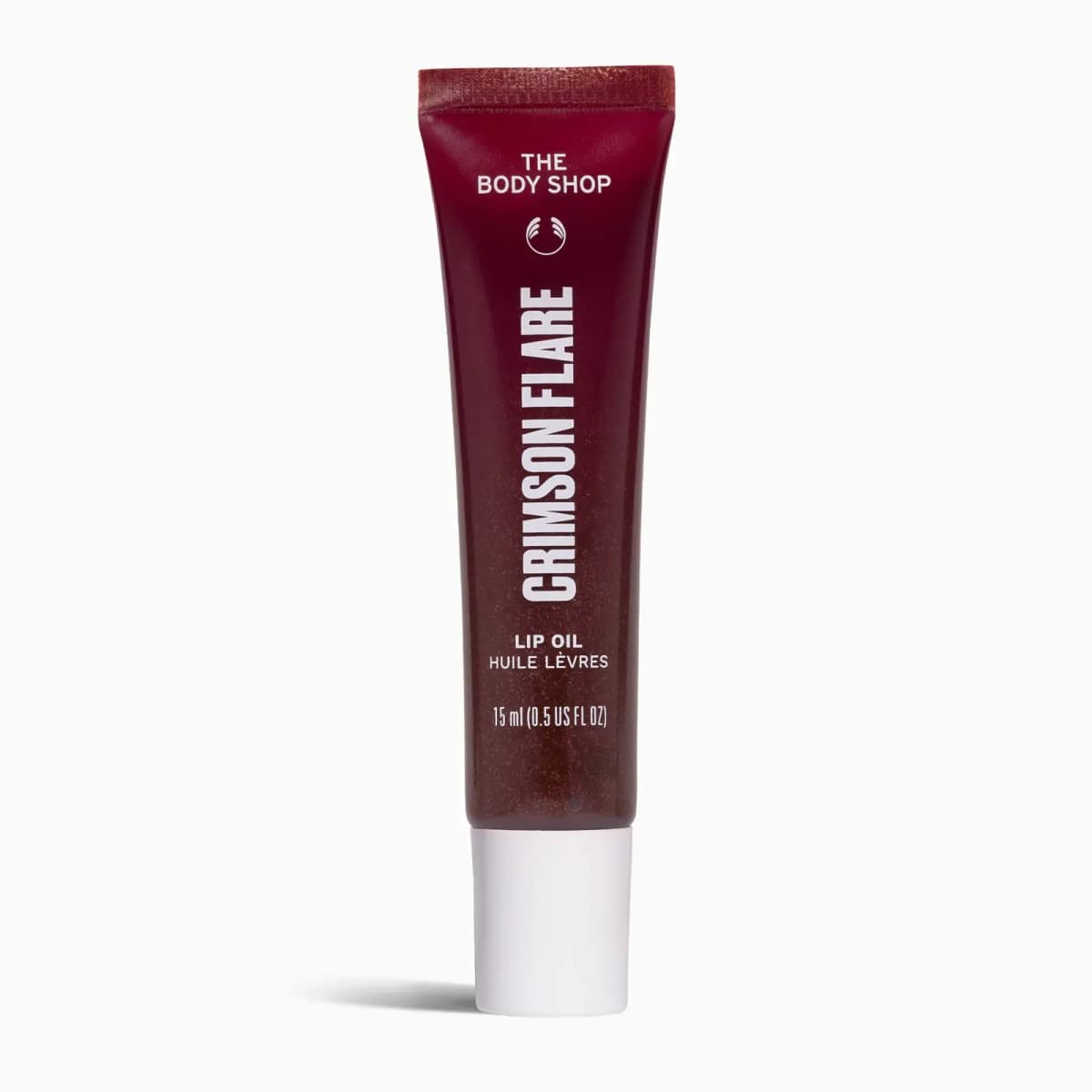 Crimson Flare lip oil in a deep red shimmering tube with white cap