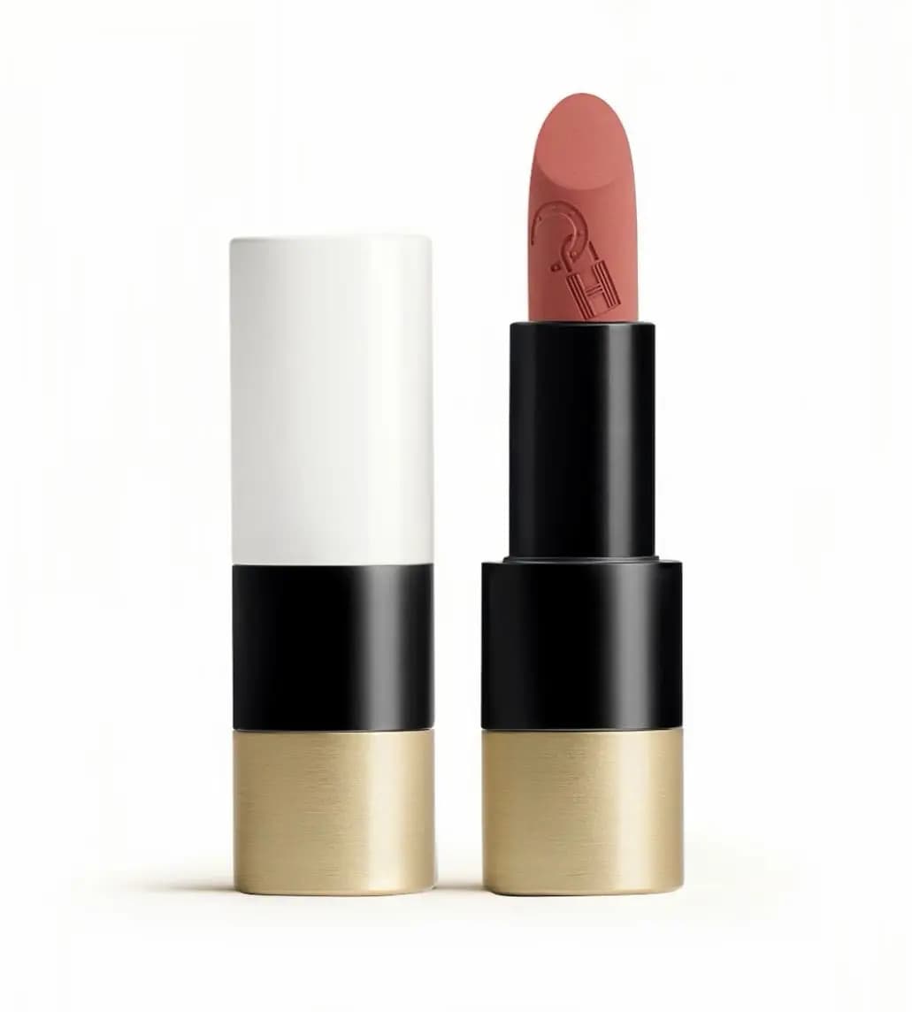Rouge Hermès lipstick with a peachy-rose bullet in a white, black and brushed-gold case beside its cap