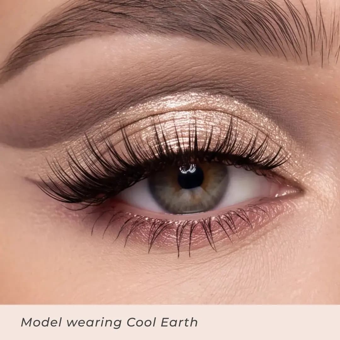 Close-up eye wearing Cool Earth with a champagne shimmer lid, soft taupe crease and rosy lower lash line