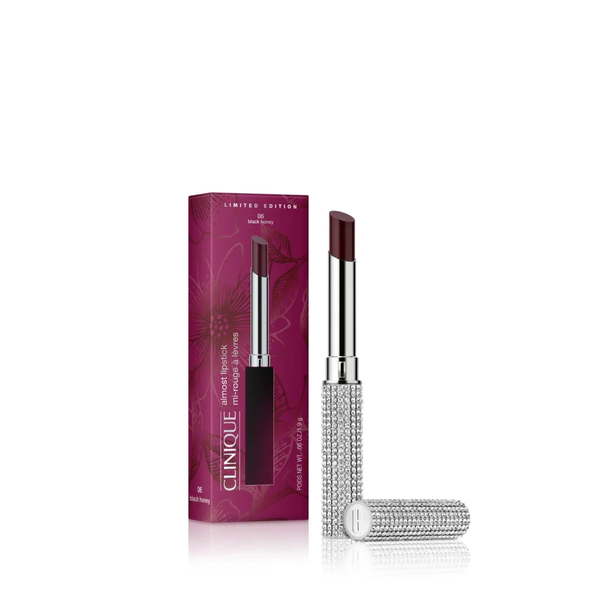 Clinique Limited-Edition Almost Lipstick in Black Honey in crystal-coated silver case beside magenta floral box
