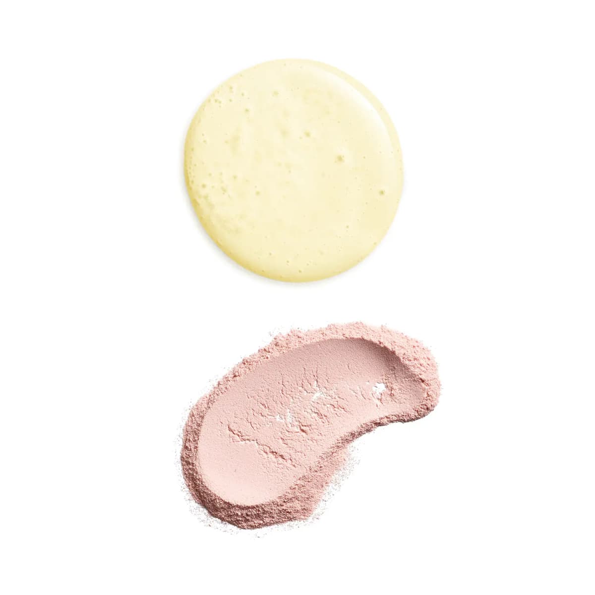 Swatches of a pale yellow bubbly liquid and a soft pink cleansing powder smear on a white background