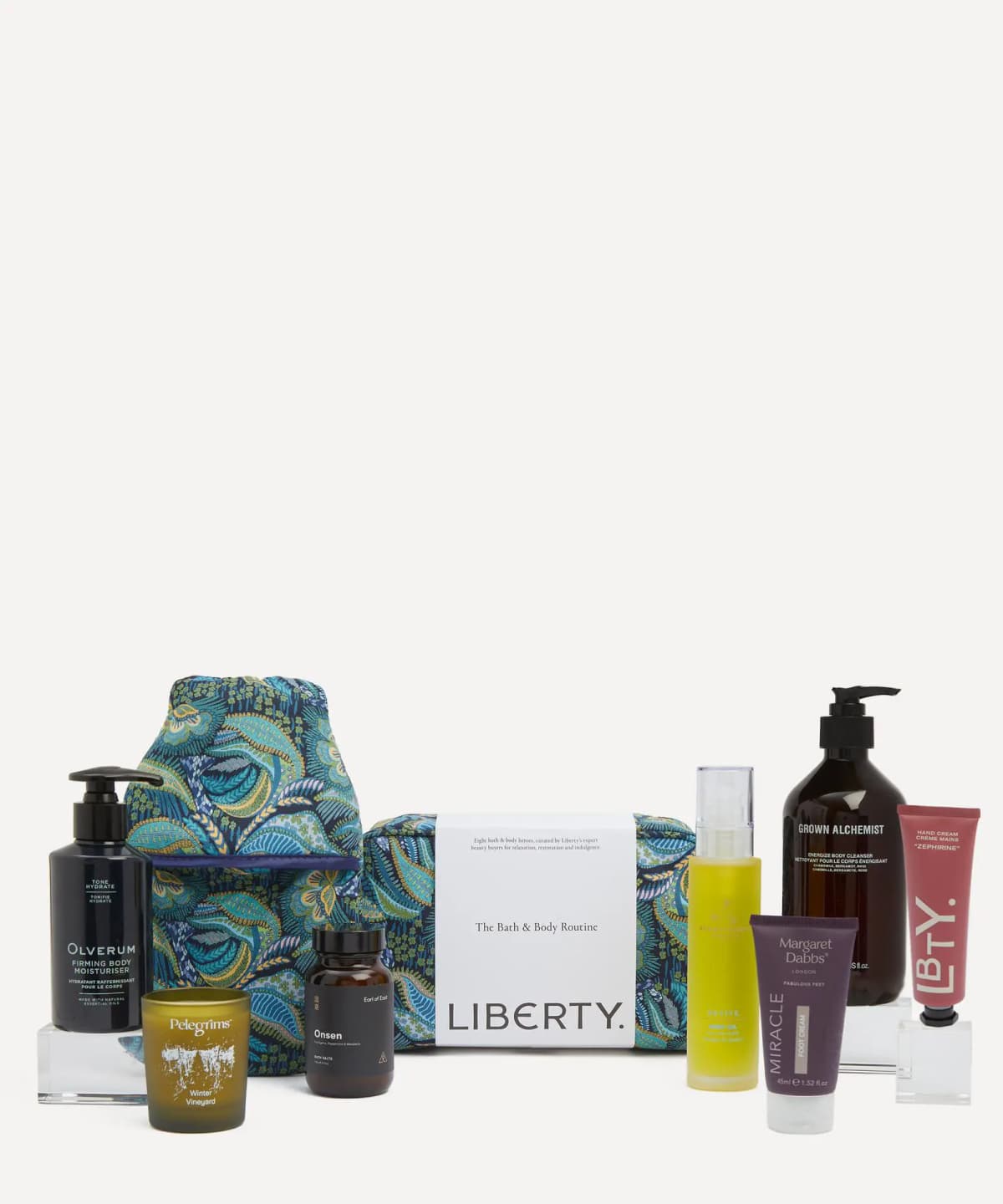 Kit products arranged around the Medusa print wash bag banded with "The Bath & Body Routine" Liberty label