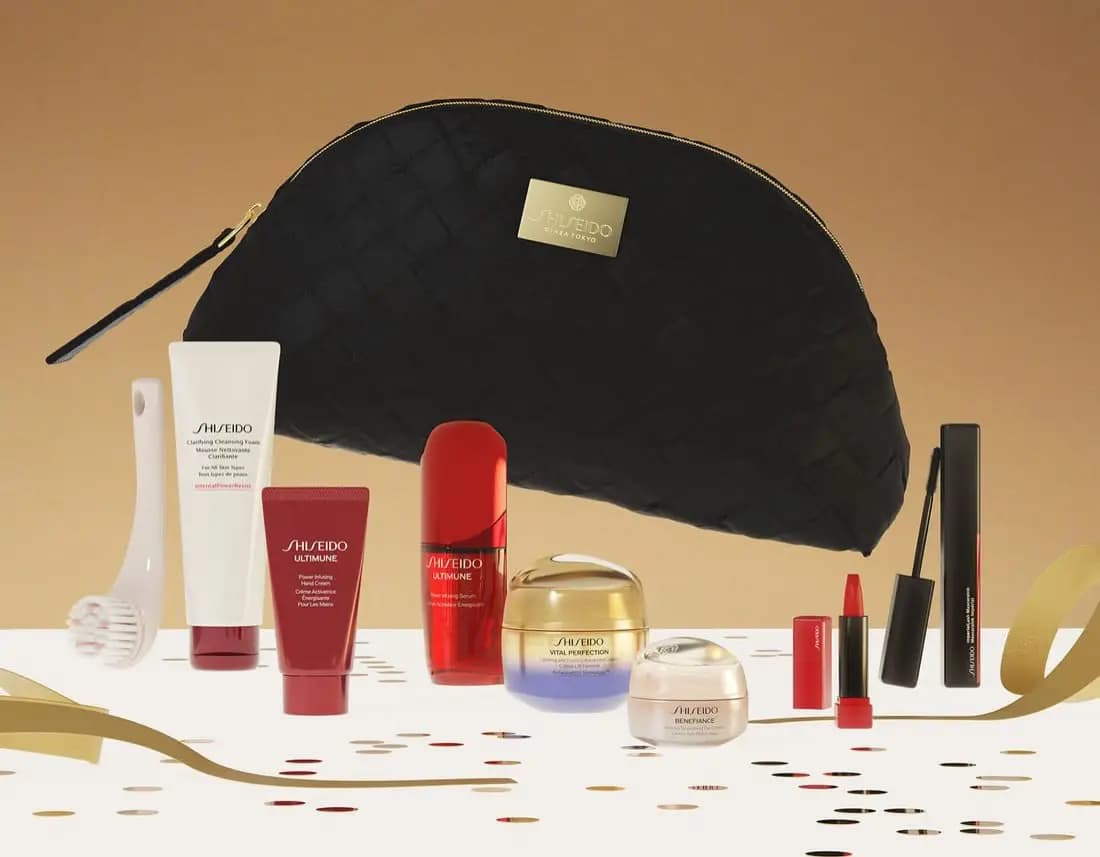 Shiseido Blockbuster Vanity Kit 2026 with a black woven pouch, cleansing foam, massage brush, Ultimune serum and hand cream, Vital Perfection cream, Benefiance eye cream, lipstick and mascara