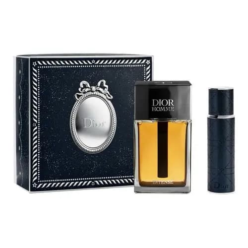 Navy glitter box with silver oval medallion and bow next to a Dior Homme Intense fragrance and black travel spray