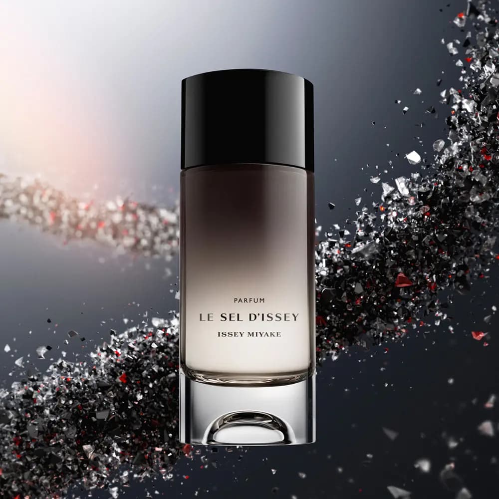 Le Sel d'Issey Parfum bottle floating against a sweeping stream of black, silver and red crystal shards on grey